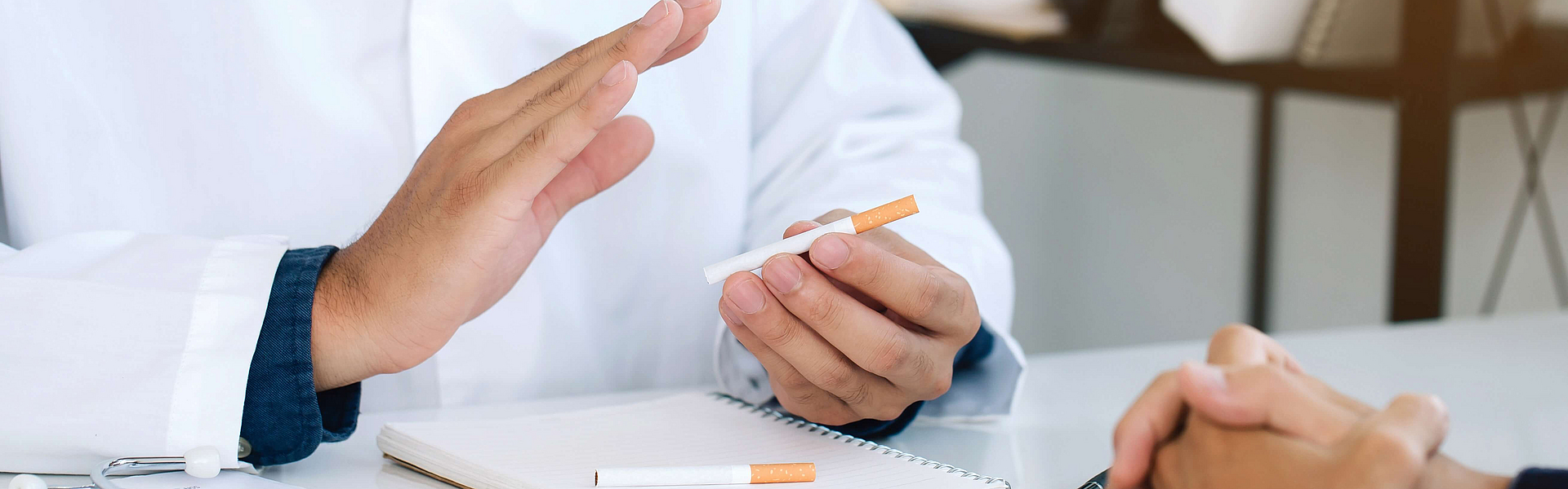Arzt mit Zigarette im Patientengespräch