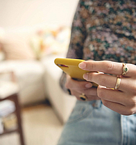 Man sieht nur das Smartphone, eine Frau tippt auf dem Display. 